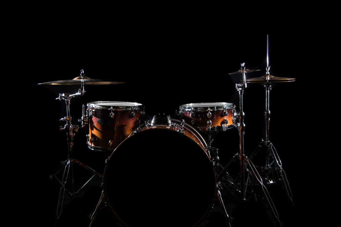 Drum Set On A Stage At Dark Background. Musical Drums Kit On Stage. Vintage look with smoke effect