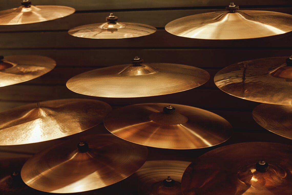 Visiting musical instrument store. Different types of drum cymbals for your ideal drum set. Music concept. Musical instrument